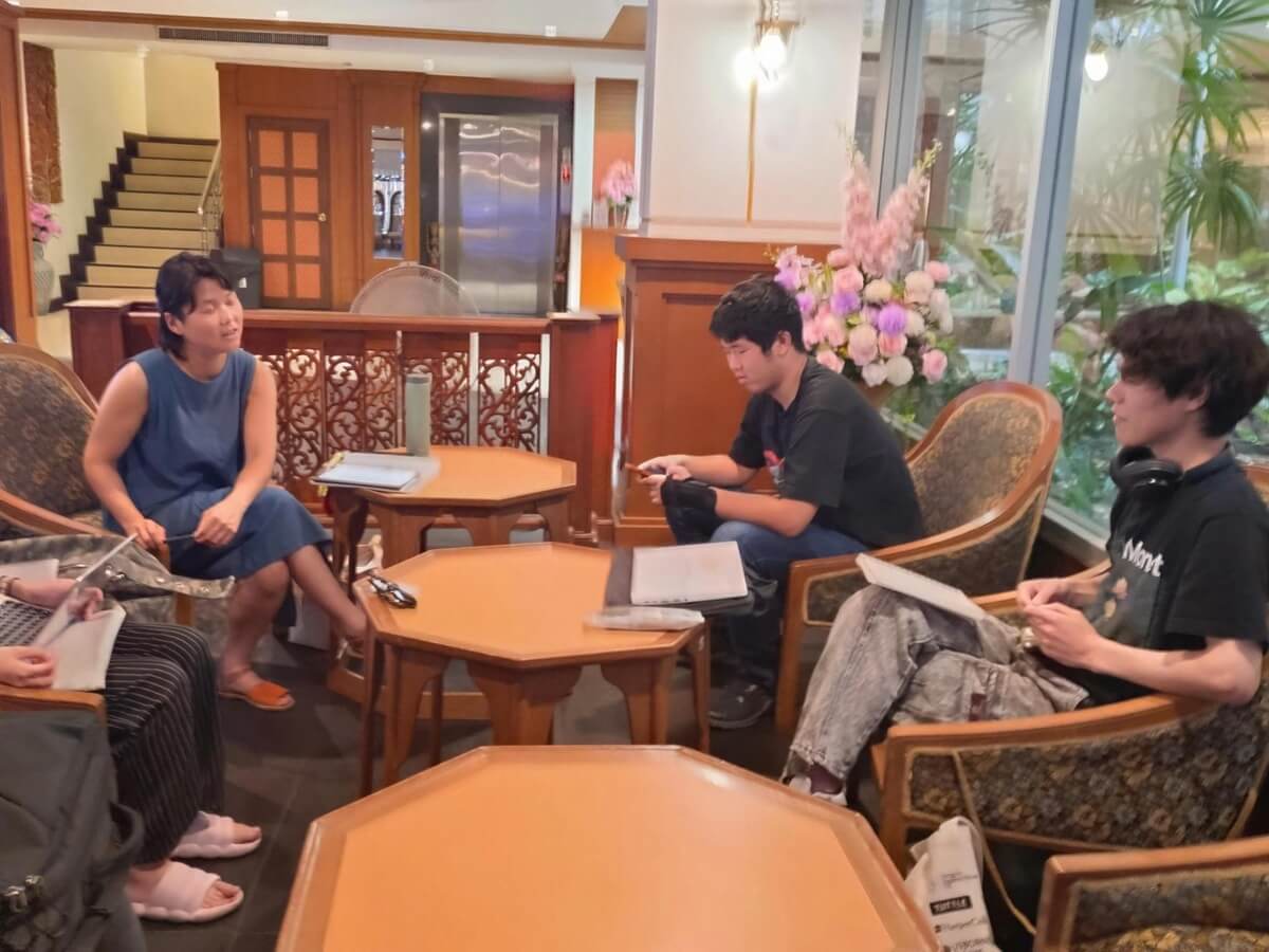 Students receiving feedback from faculty member (Bangkok, Thailand)