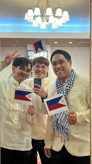 Photo: John (at left) wearing traditional attire at a cultural festival during an international exchange camp held in Fukuoka.