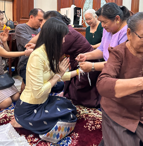 A Baci ceremony in Laos. Participants tie white cotton strings around each other’s wrists as a symbol of blessings, happiness, and hopes for future success.