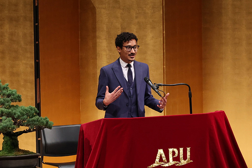 Saif gives a speech on behalf of current students at an APU entrance ceremony.